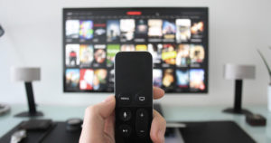 Leaptel person holding tv remote